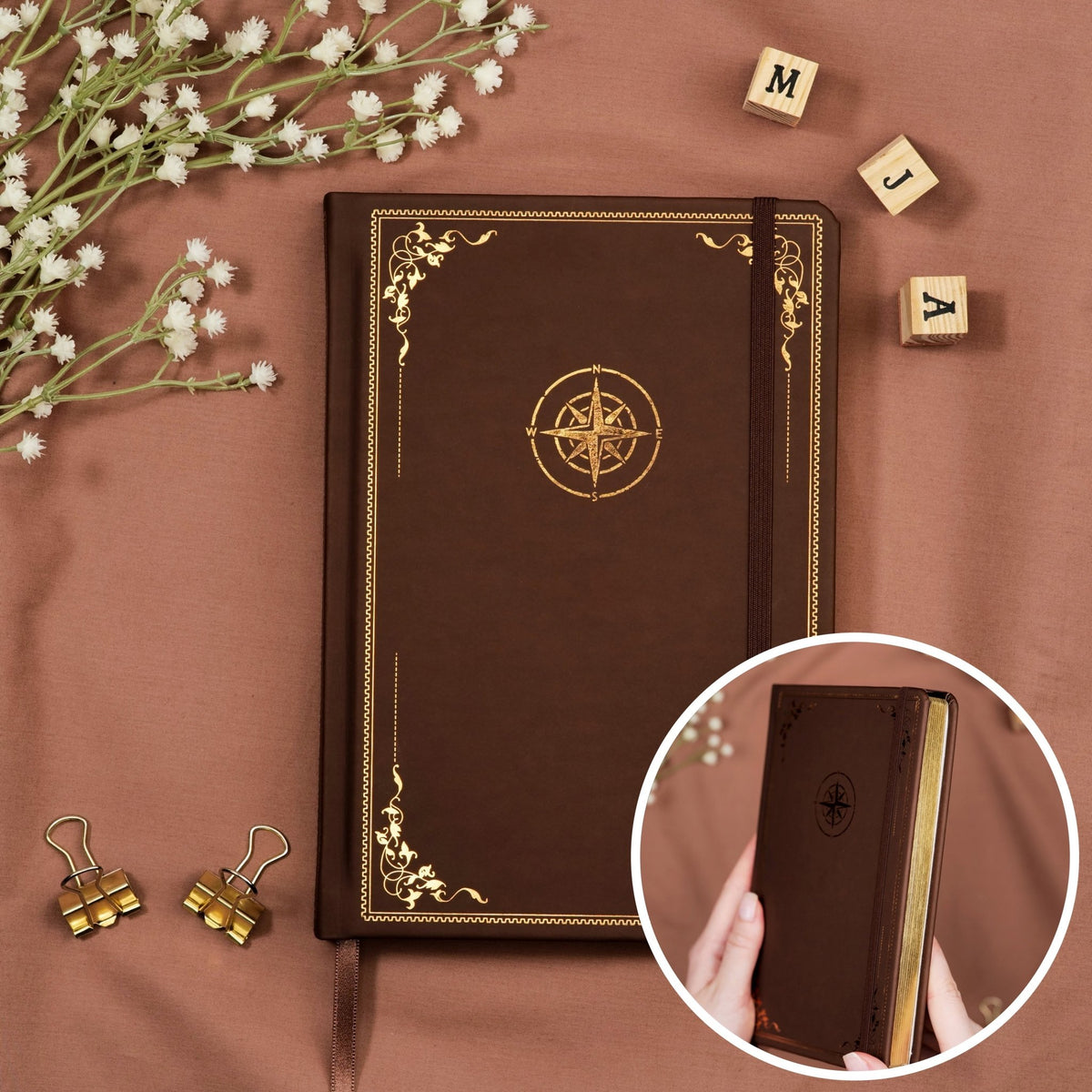 Premade travel journal made of Italian vegan leather with gold edges and an embossed gold copper compass design.
