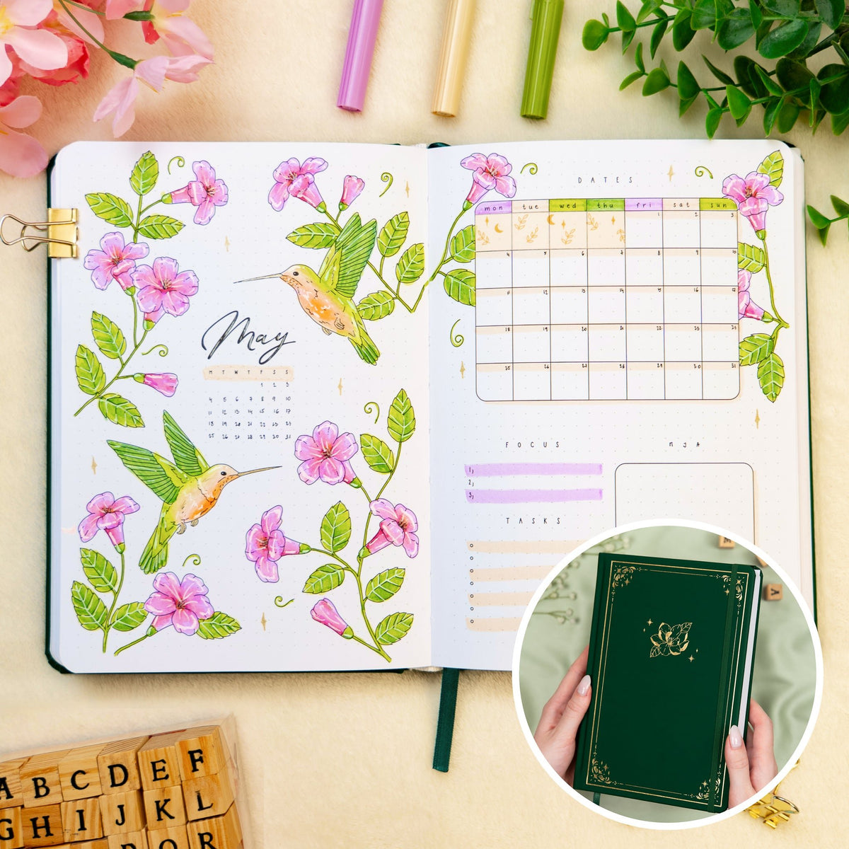Opened premade bullet style journal with flowers and hummingbirds