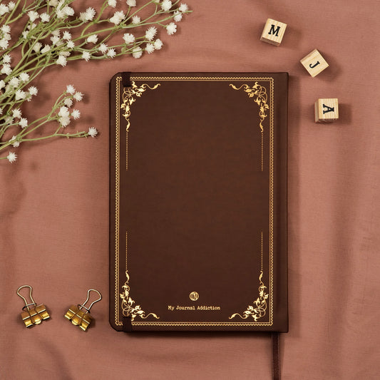 Vegan leather back cover of the Brown dotted premade bullet style travel journal with embossed gold copper logo detail.