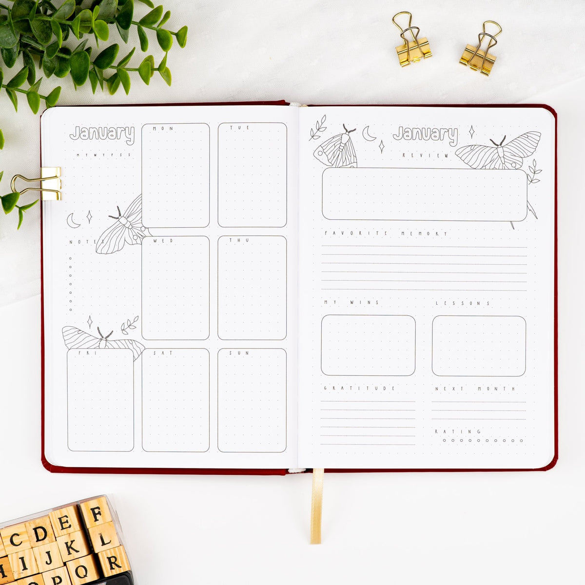 Fifth monthly weekly layout of a premade journal with calligraphy January title, calendar, days and notes section and a monthly review page.