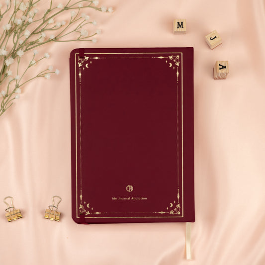 Vegan leather back cover of the Forbidden Fruit red dotted premade bullet style journal with embossed gold logo detail.