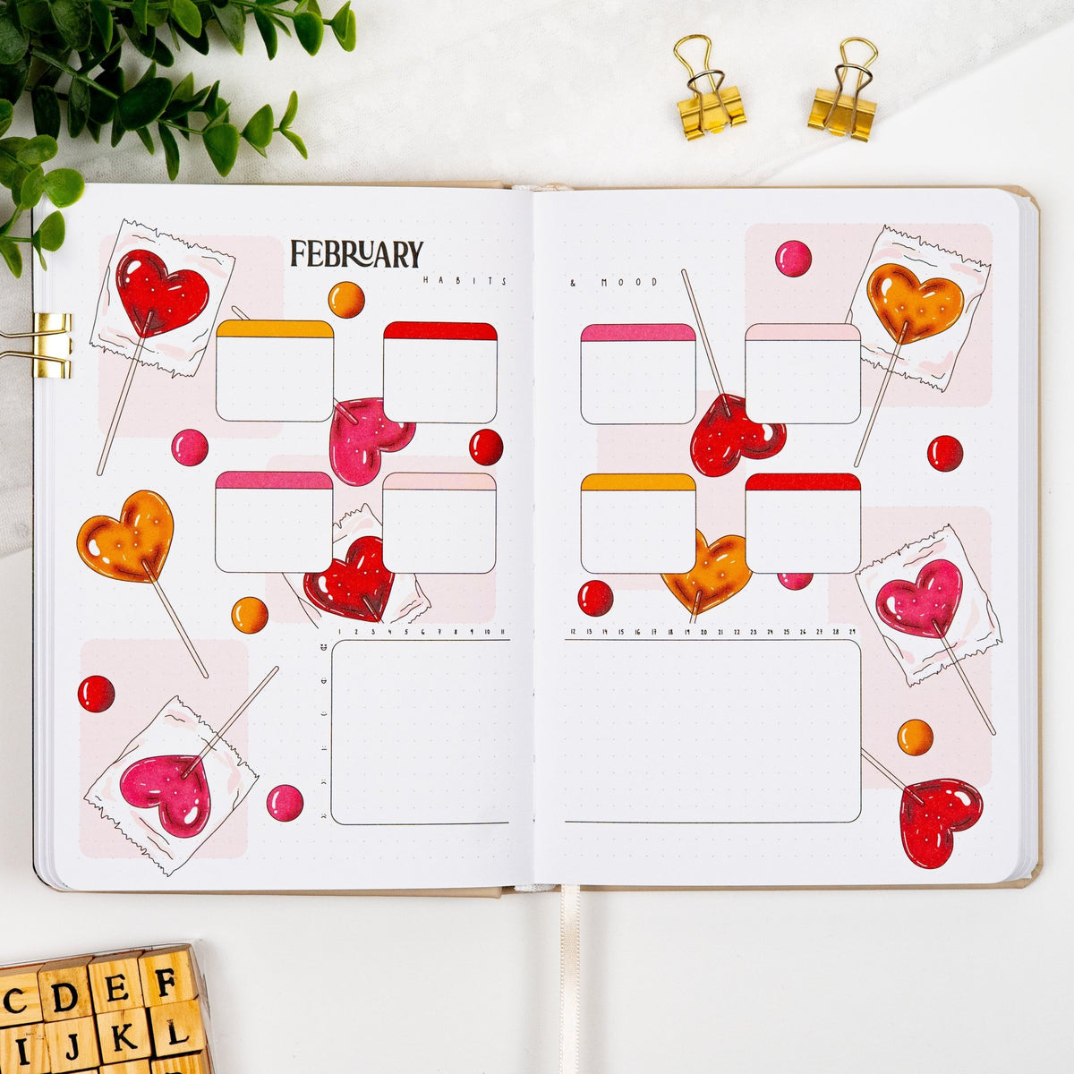 February habits and mood tracker spread of a pre-colored premade journal, with heart Lollipop artwork.