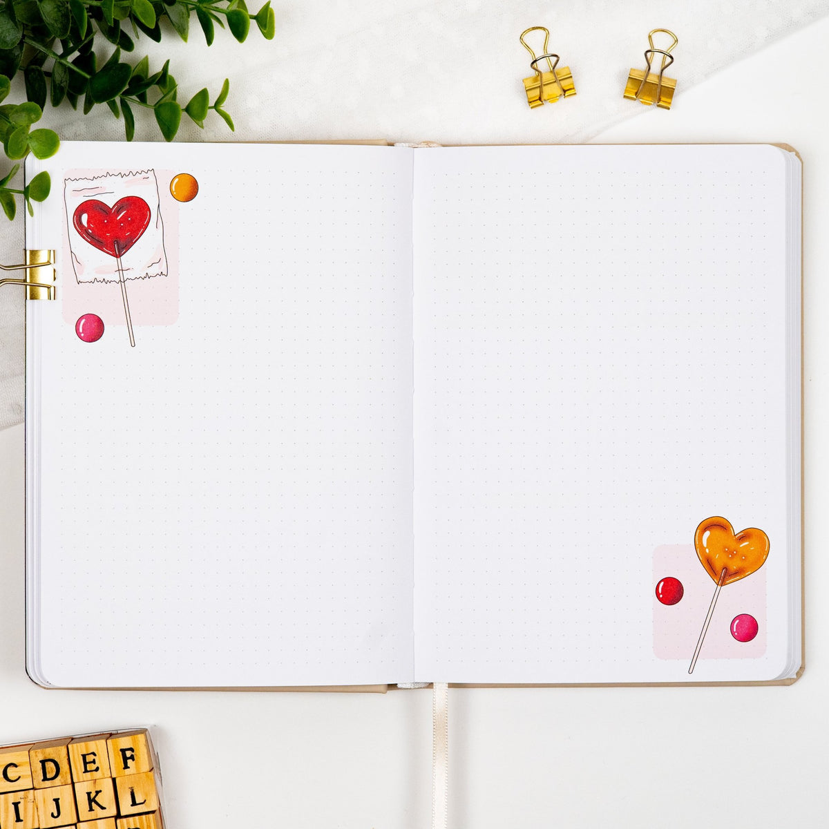 Monthly empty pages of a pre filled premade journal, with Heart Lollipop illustrations in the corners.