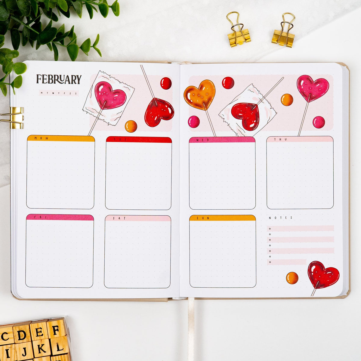 First monthly weekly layout of a precolored premade journal, with calligraphy February title, calendar, days and notes section.