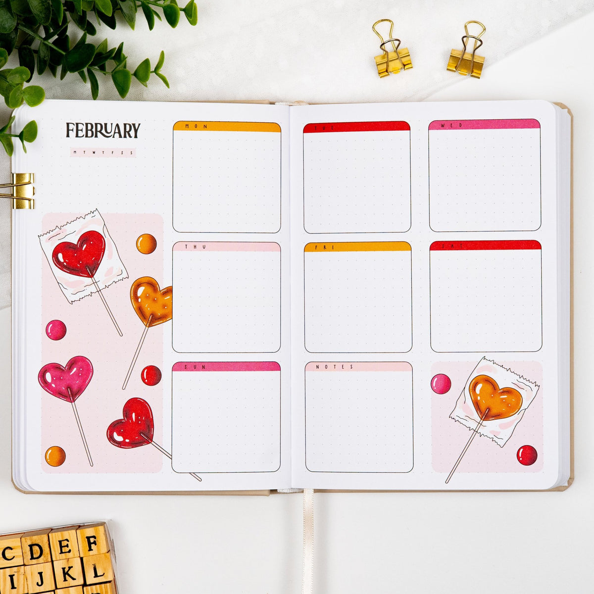 Fourth monthly weekly layout of a colored premade journal with calligraphy February title, calendar, days and notes section.