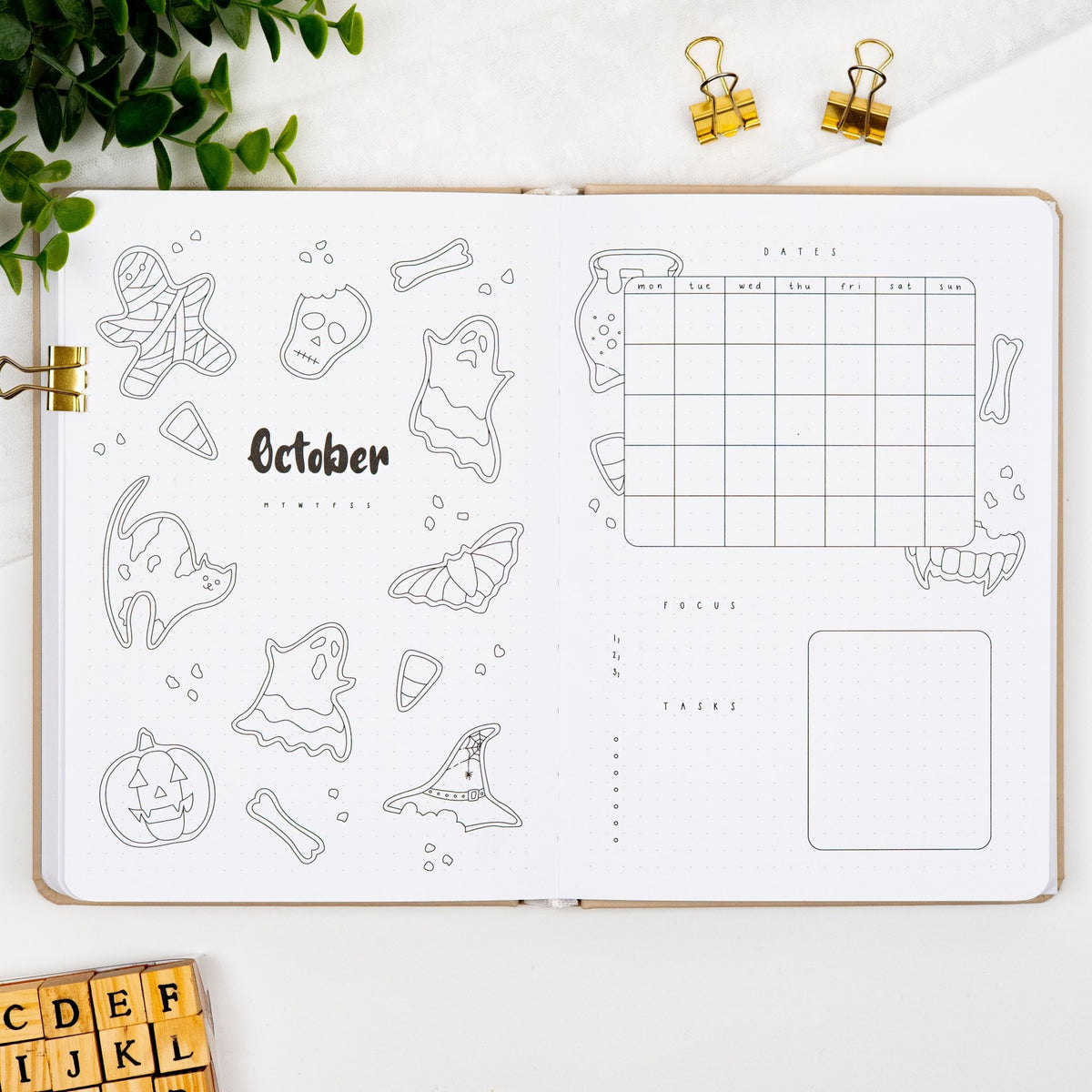 October monthly cover page of a premade journal, with Halloween sugar cookies artwork, calendar, and dedicated sections for goals and tasks.