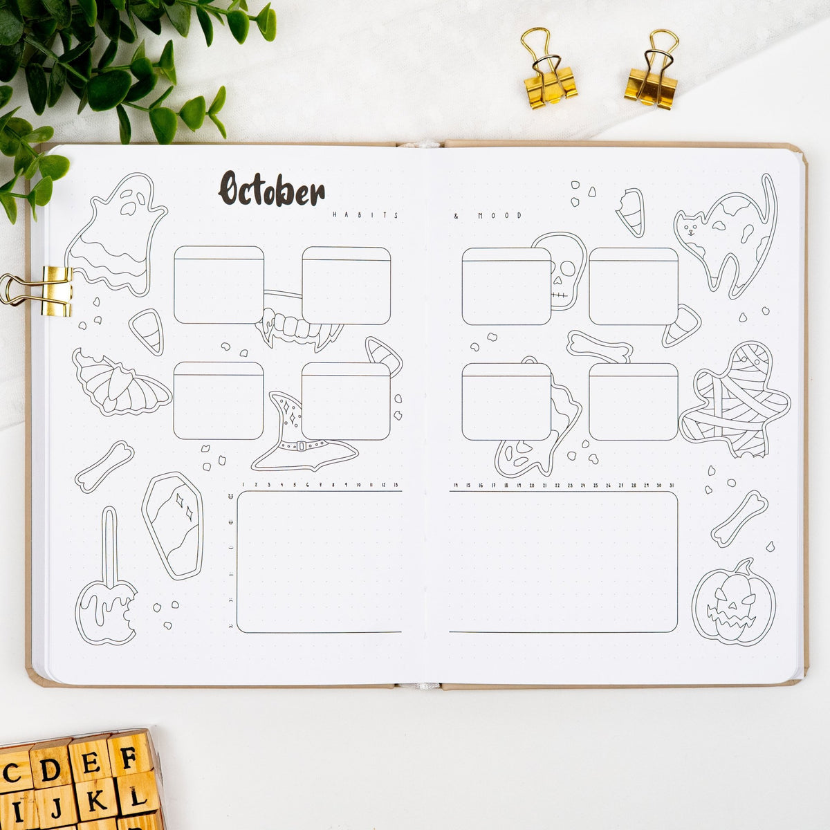 October habits and mood tracker spread of a premade journal, with Halloween sugar cookies artwork