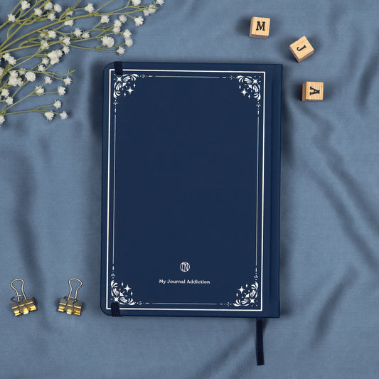 Vegan leather back cover of the blue midnight premade bullet style journal with embossed silver logo detail.