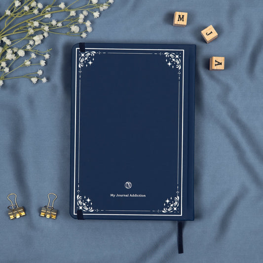 Vegan leather back cover of the blue midnight premade bullet style journal with embossed silver logo detail.