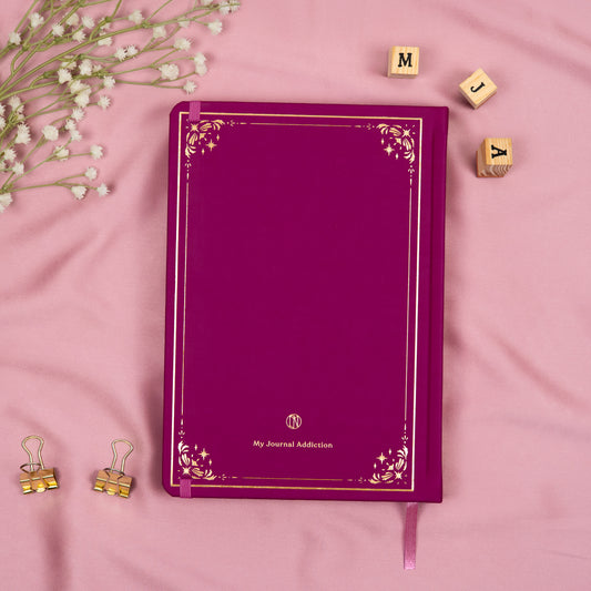 Vegan leather back cover of the Plum premade bullet style journal with embossed gold logo detail.