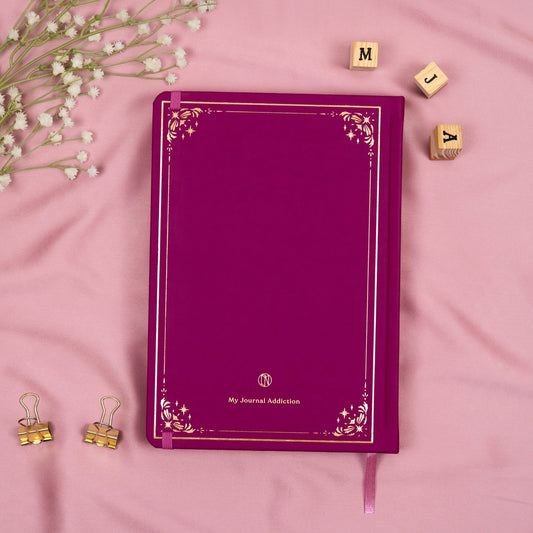 Vegan leather back cover of the Plum premade bullet style journal with embossed gold logo detail.