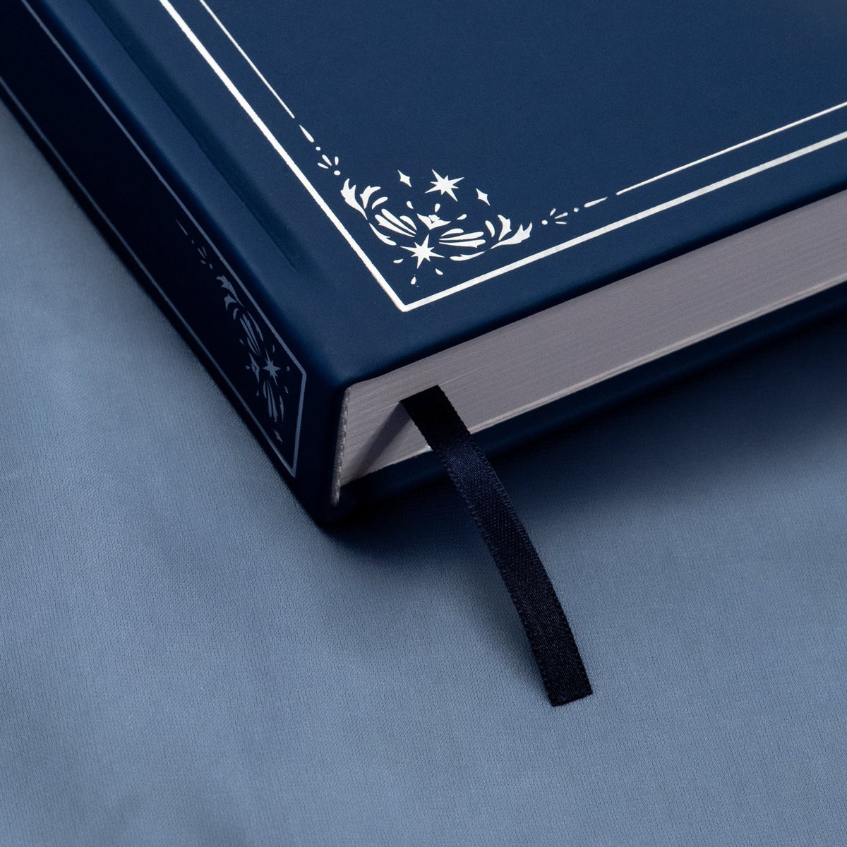 Showing the embossed silver detail and satin bookmark of the Midnight blue premade bullet style journal.