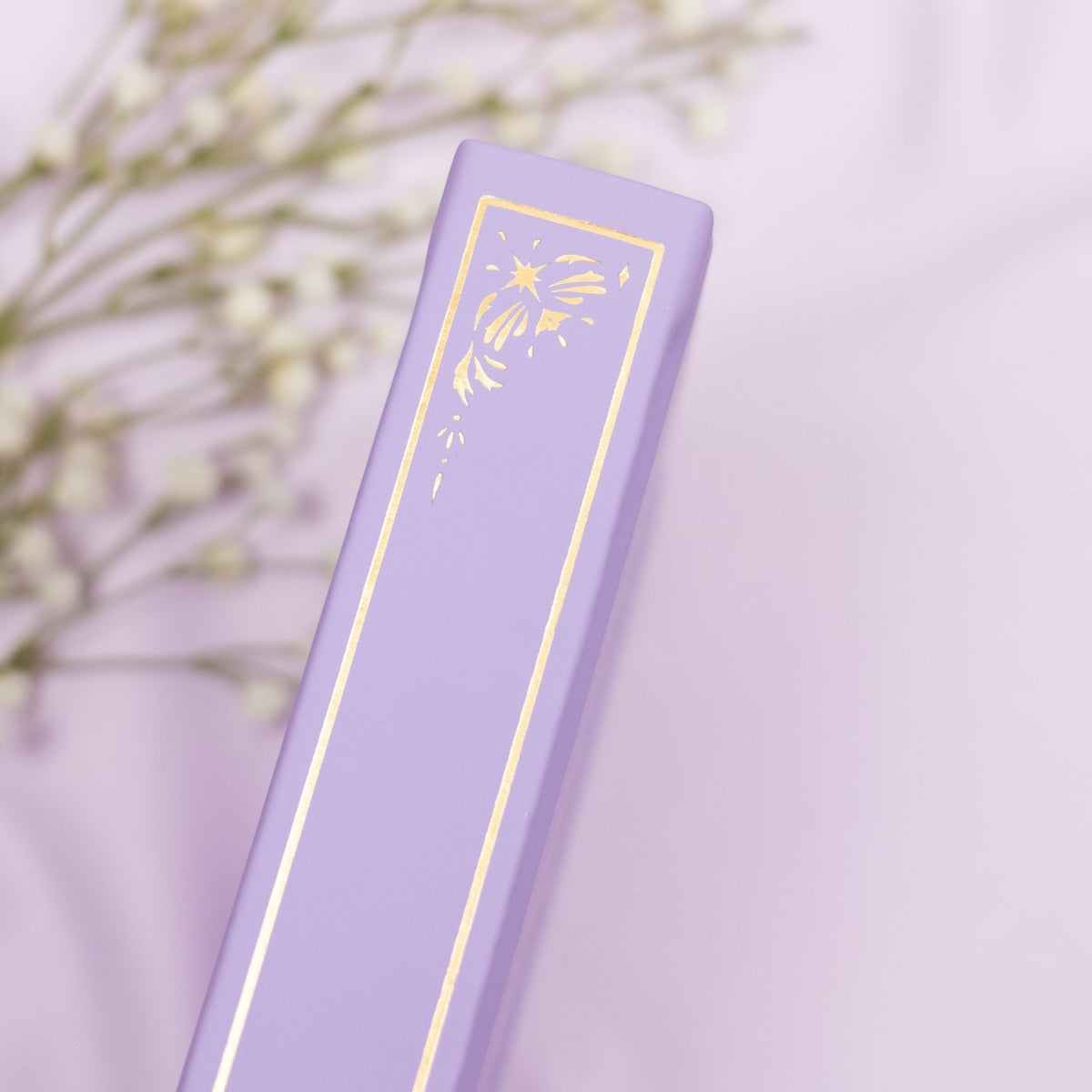 Showing the embossed gold detail on the spine of the Lavender premade bullet style journal.