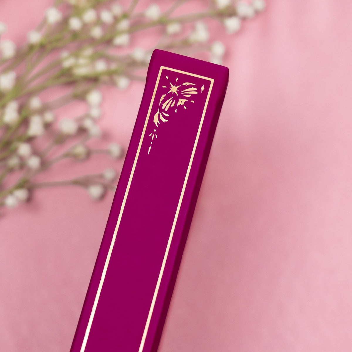 Showing the embossed gold detail on the spine of the Plum premade bullet style journal.