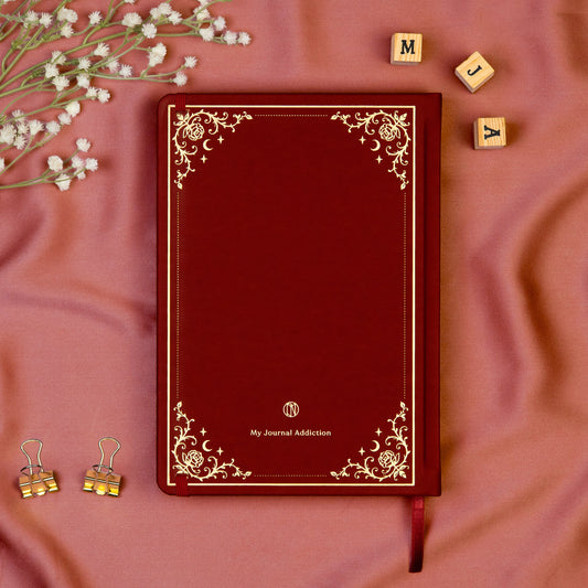 Vegan leather back cover of the Burgundy premade bullet style journal with embossed gold logo detail.