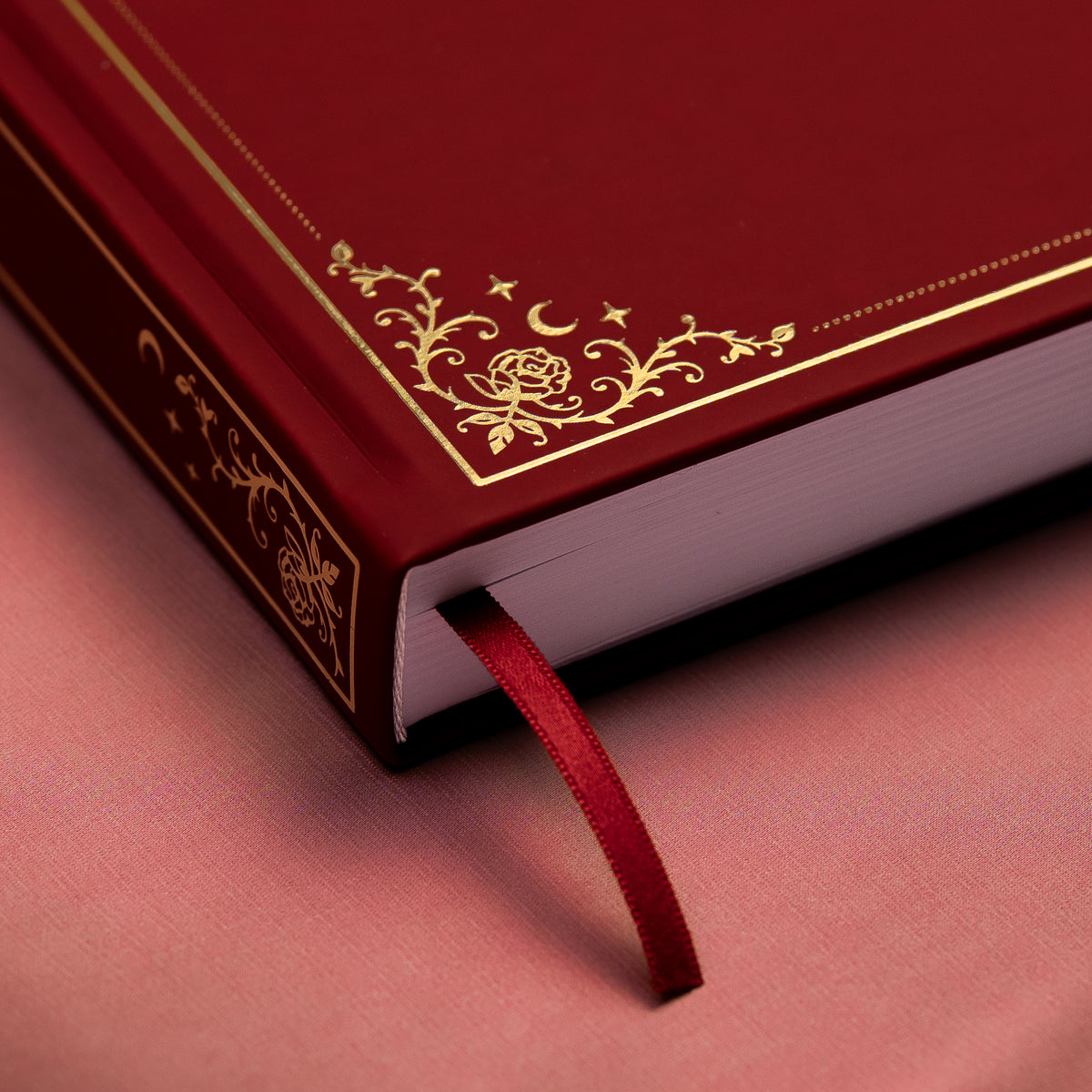 Showing the embossed gold detail and satin bookmark of a premade bullet style journal.