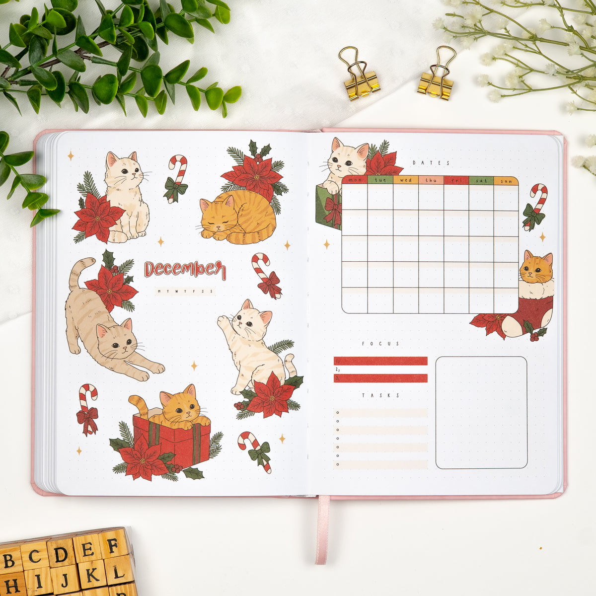 colored in December monthly cover page in a premade journal, with a cute christmas cats theme, calendar, and dedicated sections for goals and tasks.
