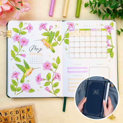 Opened premade bullet style journal with flowers and hummingbirds