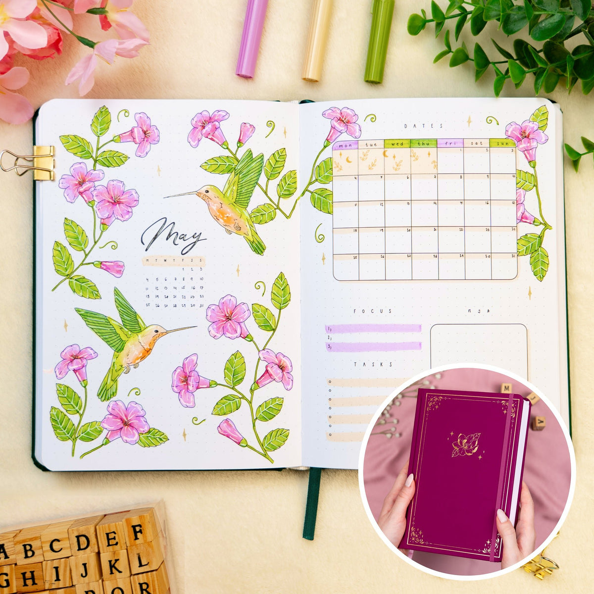 Opened premade bullet style journal with flowers and hummingbirds