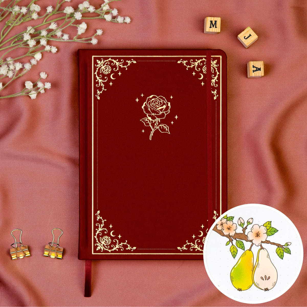 Burgundy colored Premade bullet style journal made of Italian vegan leather with an embossed gold rose design.