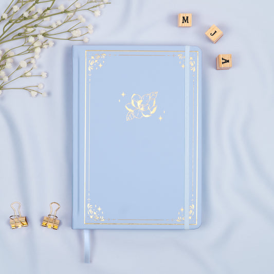 Cloud Light Blue premade dotted bullet style journal made of Italian vegan leather with an embossed gold magnolia design.