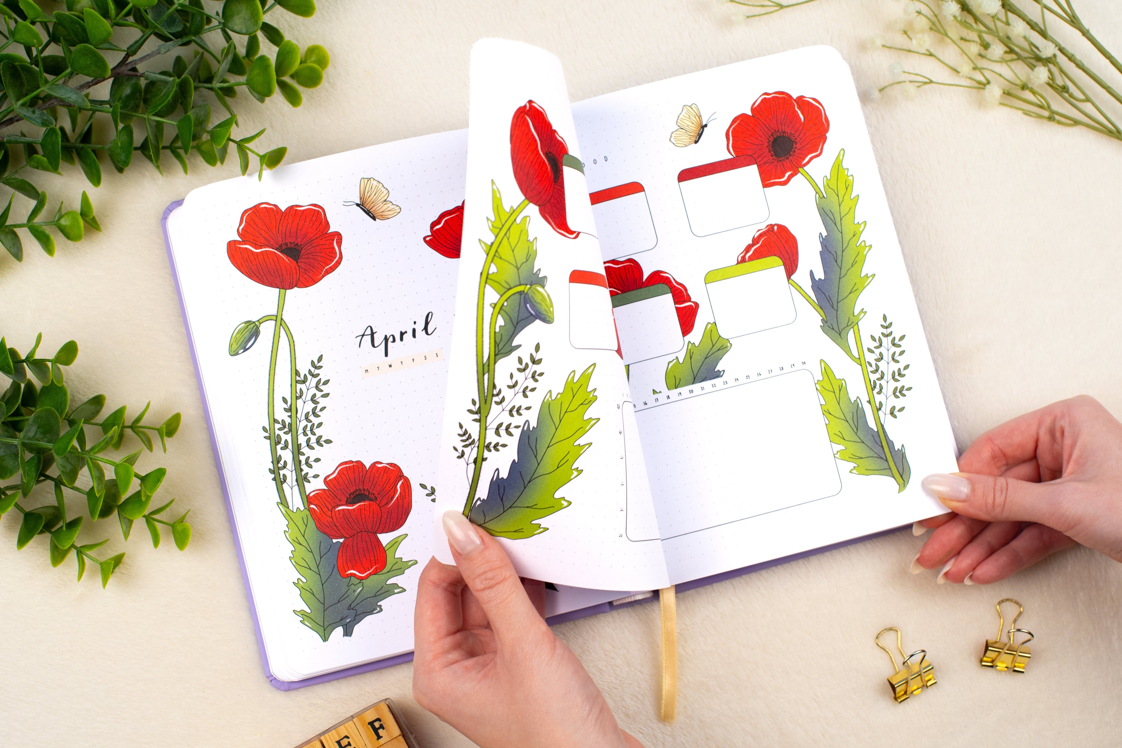 Opened Premade Bullet Style Journal on April Cover Page with Poppies and Butterflies