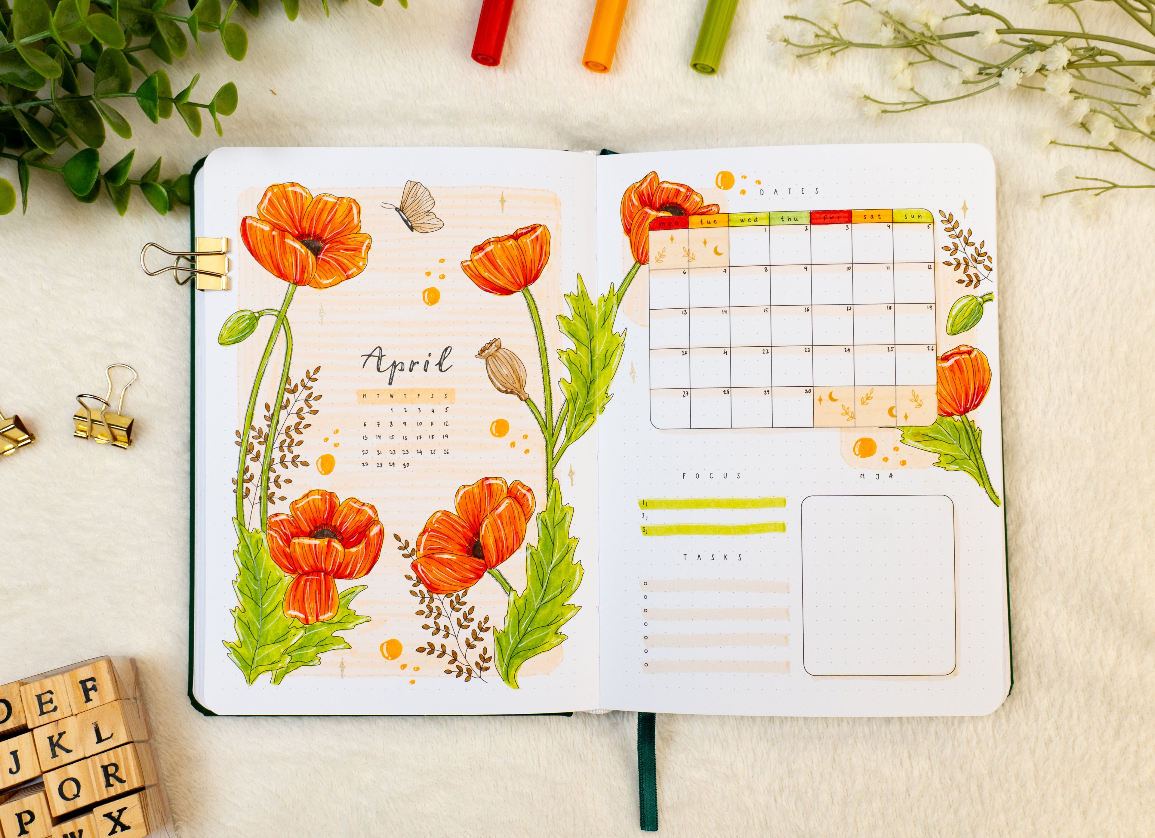 Open premade bullet style journal with poppies and butterflies