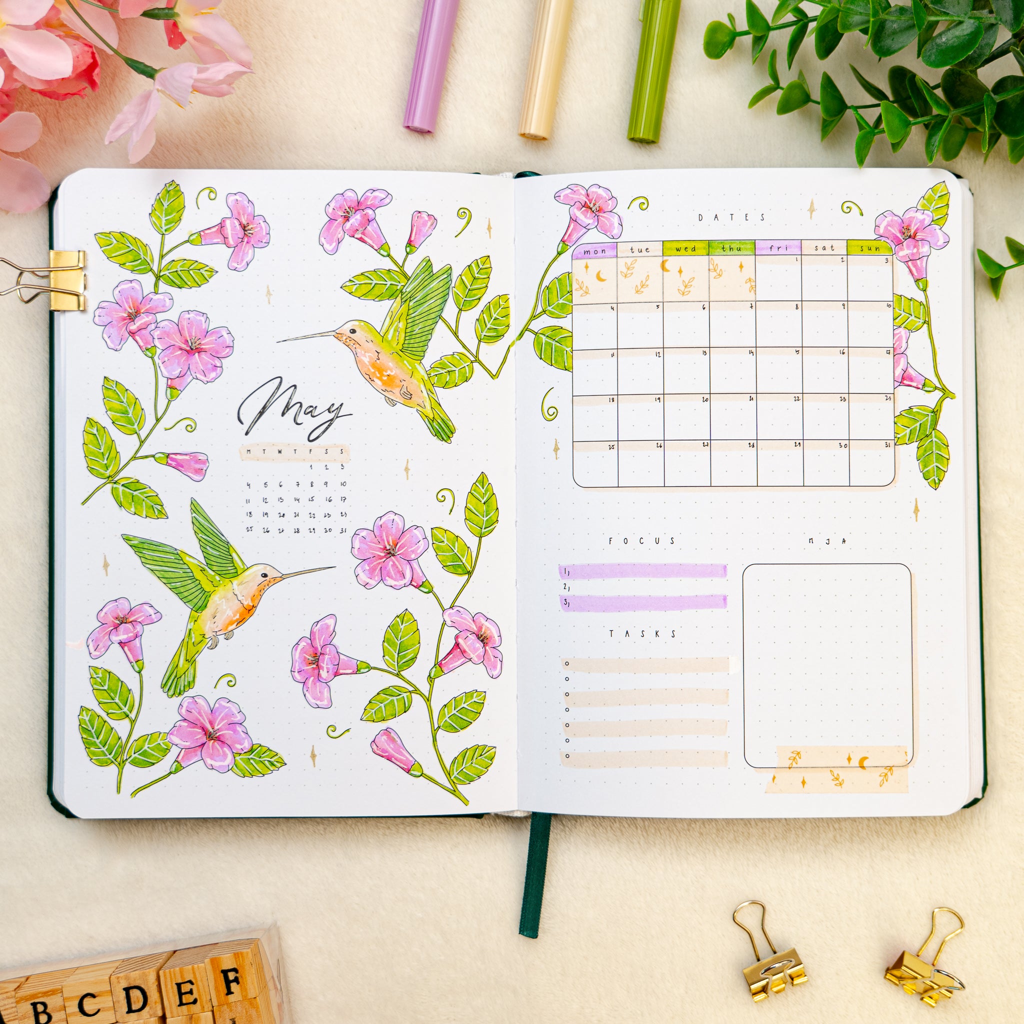 Open premade bullet style journal with hummingbirds and flowers