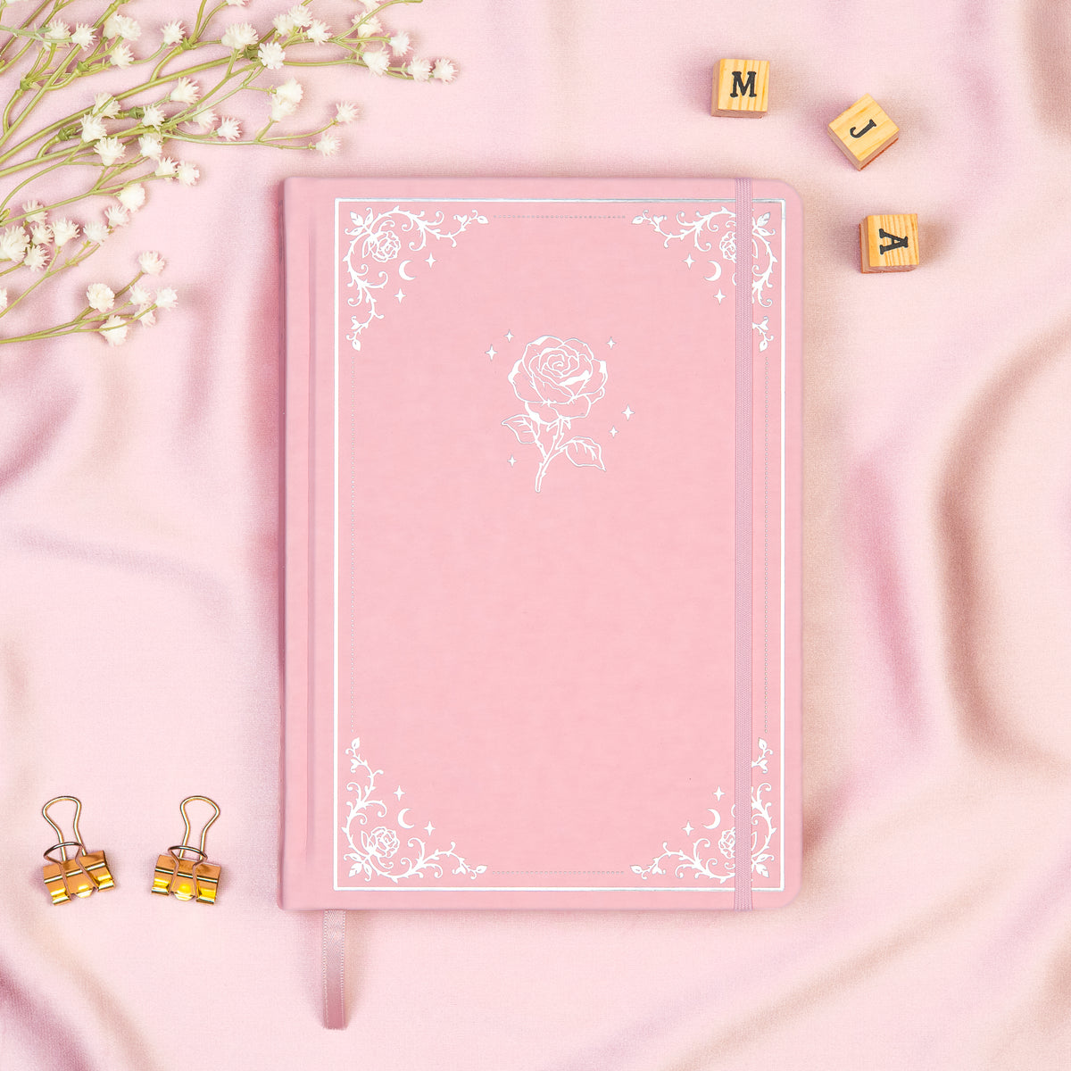 Pink Premade bullet style journal made of Italian vegan leather with an embossed gold rose design.