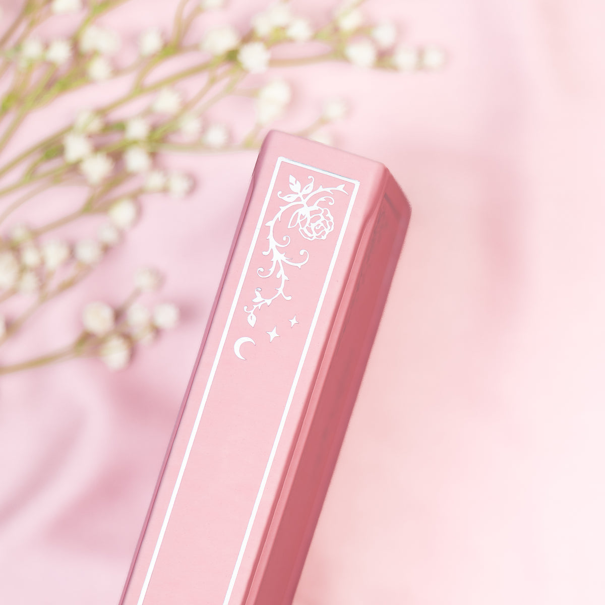 Close up of the embossed gold detail on the spine of the Pink premade bullet style journal.