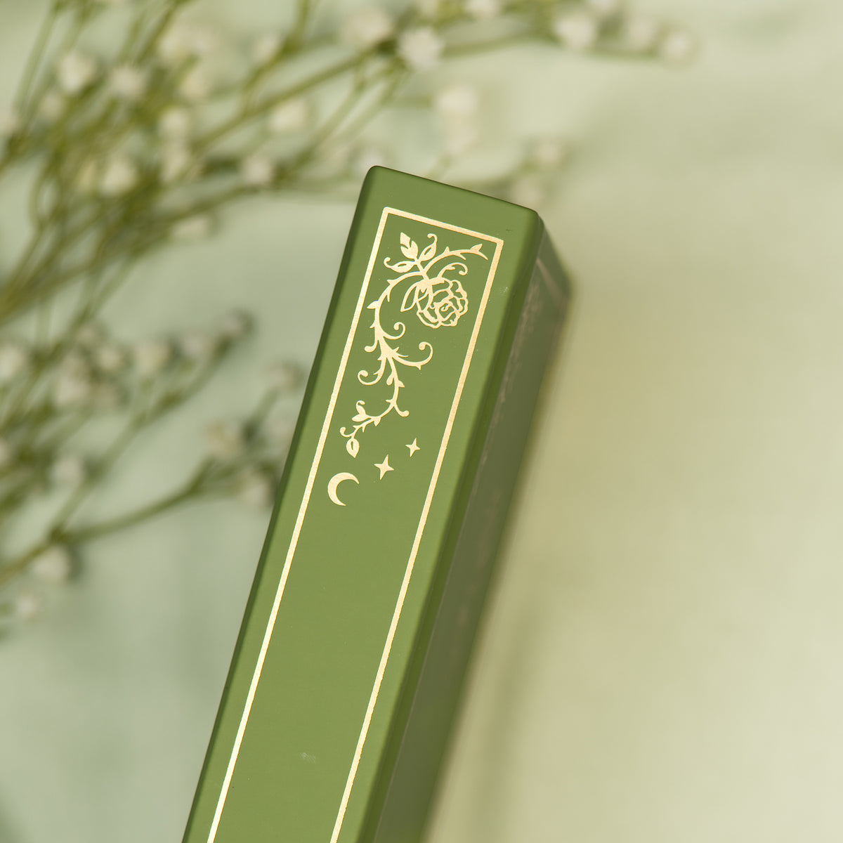 Close up of the embossed gold detail on the spine of the Sage premade bullet style journal.