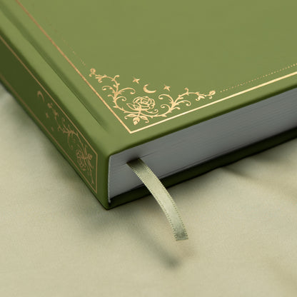 Embossed gold detail and satin pink bookmark of a premade bullet style journal.
