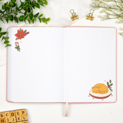 Monthly empty pages of a colored predesigned journal decorated with lineart drawings of a sleeping cat in the bottom right corner and a christmas flower in the top left. 