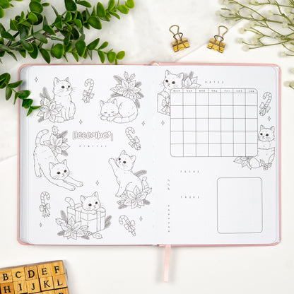 December monthly cover page in a premade journal, with a cute christmas cats theme, calendar, and dedicated sections for goals and tasks.