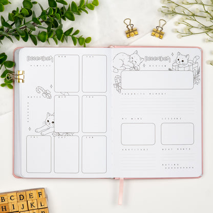 Fifth monthly weekly layout of a premade journal with calligraphy title, calendar, days and notes section and a monthly review page.